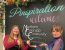 Two "Vana Whites" draw attention to the chalk board located at Pinspiration Loveland that welcomes members of the Northern Colorado Community.